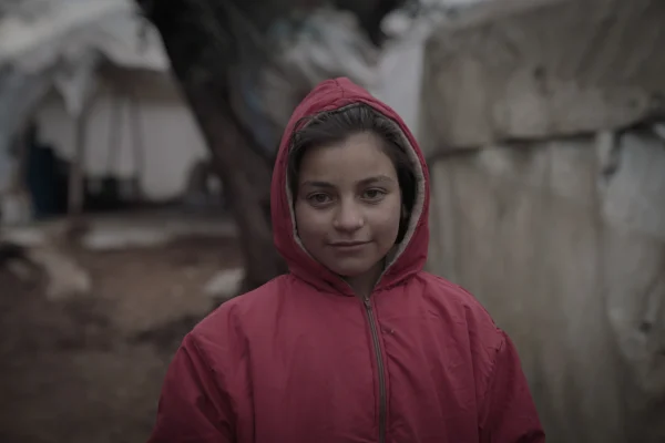 Little girl wearing a coat, smiling